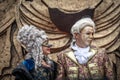 Senior man and woman stand in medieval carnival costumes and masks in Piazza San Marco in Venice Royalty Free Stock Photo