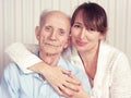 Senior man, woman with their caregiver at home. Royalty Free Stock Photo