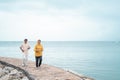 Senior man and woman together running on the beach Royalty Free Stock Photo