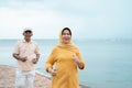 Senior man and woman together running on the beach Royalty Free Stock Photo