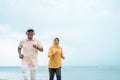 Senior man and woman together running on the beach Royalty Free Stock Photo