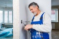 Senior man working on the electrical installations in  appartment Royalty Free Stock Photo