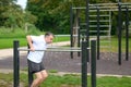 Senior man working out on exercise bars in a spring park Royalty Free Stock Photo