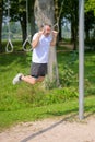 Senior man working out on exercise rings in a park Royalty Free Stock Photo