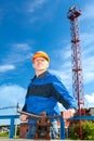 Senior man in working uniform with valve gate