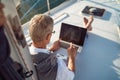 Man is working during the vacation on a sailboat Royalty Free Stock Photo