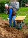 Senior man preparing manure for fertilizing land