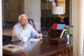 Senior Man Writing Memoirs In Book Sitting At Desk Royalty Free Stock Photo