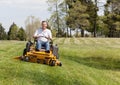 Senior man on zero turn lawn mower on turf Royalty Free Stock Photo