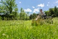 Senior man on zero turn lawnmower in meadow Royalty Free Stock Photo