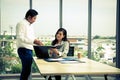 Senior Manager check appointment from diary with secretary in meeting room