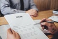 Senior manager reading a resume during a job interview, Employer