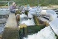 Senior manual worker turning cut-off valve at plant Royalty Free Stock Photo