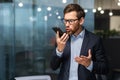 Senior mature boss angry shouting talking on phone, businessman in business suit inside office near window Royalty Free Stock Photo