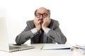 Mature business man with bald head on his 60s working stressed and frustrated at office computer laptop desk looking desperate Royalty Free Stock Photo