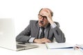 Mature business man with bald head on his 60s working stressed and frustrated at office computer laptop desk looking tired Royalty Free Stock Photo