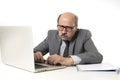 Senior mature busy business man with bald head on his 60s working stressed and frustrated at office computer laptop desk looking a Royalty Free Stock Photo