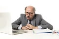 Senior mature busy business man with bald head on his 60s working stressed and frustrated at office computer laptop desk looking a Royalty Free Stock Photo