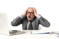 Senior mature busy business man with bald head on his 60s working stressed and frustrated at office computer laptop desk looking a Royalty Free Stock Photo