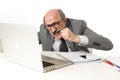 Senior mature busy business man with bald head on his 60s working stressed and frustrated at office computer laptop desk looking a Royalty Free Stock Photo