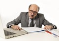 Senior mature busy business man with bald head on his 60s working stressed and frustrated at office computer laptop desk Royalty Free Stock Photo