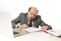 Senior mature busy business man with bald head on his 60s working stressed and frustrated at office computer laptop desk Royalty Free Stock Photo