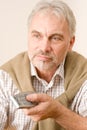 Senior mature man with remote control Royalty Free Stock Photo