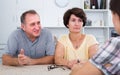 Senior mature man and woman listening to young woman