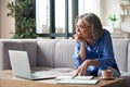 Senior older woman watching webinar on laptop working from home. Royalty Free Stock Photo