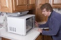 Senior Mature Woman Cooking Microwave Oven Kitchen Royalty Free Stock Photo