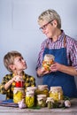 Senior mature woman with grandson holding in hands preserved food Royalty Free Stock Photo