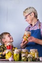 Senior mature woman with grandson holding in hands preserved food Royalty Free Stock Photo