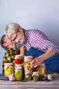 Senior mature woman with grandson holding in hands preserved food Royalty Free Stock Photo