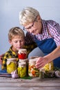 Senior mature woman with grandson holding in hands preserved food Royalty Free Stock Photo