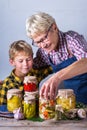 Senior mature woman with grandson holding in hands preserved food Royalty Free Stock Photo