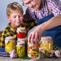 Senior mature woman with grandson holding in hands preserved food Royalty Free Stock Photo