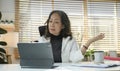 Senior mature woman is watching business training, online webinar on laptop computer while remote working from home Royalty Free Stock Photo