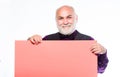 Senior means experienced. Senior man recommend something. Elderly people. Senior holding blank sign board and looking at Royalty Free Stock Photo