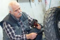 senior mechanic changing wheel modern car Royalty Free Stock Photo