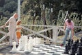 Senior man grandfather spending time with son and grandson playing chess. Happy men in different ages playing chess Royalty Free Stock Photo