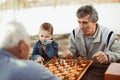 Senior men having fun and playing chess Royalty Free Stock Photo