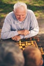 Senior men having fun and playing chess at park Royalty Free Stock Photo