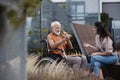 Senior man playing chess outdoors with his daughter. Royalty Free Stock Photo