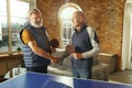 Senior men playing table tennis in workplace, having fun Royalty Free Stock Photo