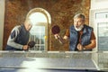 Senior men playing table tennis in workplace, having fun Royalty Free Stock Photo