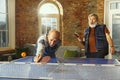 Senior men playing table tennis in workplace, having fun Royalty Free Stock Photo