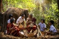 Senior Men and women are weaves basket with nephew and granddaughter and a big elephant in the forest. Old man and woman weaves Royalty Free Stock Photo