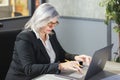 Senior middle aged business woman using laptop working on computer sitting at desk..business woman working on computer Royalty Free Stock Photo