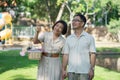 Senior middle aged couple happily embracing and reading a book together during a picnic in the park outdoors. Royalty Free Stock Photo