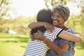 Senior Mother With Adult Daughter Hugging In Park Royalty Free Stock Photo